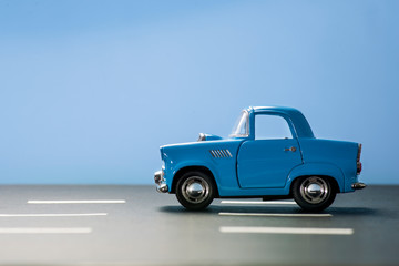 Fototapeta na wymiar Blue toy car on a blue background.