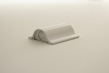 The laid on LED lamp of white color on a white wall.