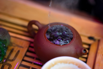 White teapot with brewed camomile. Tea ceremony