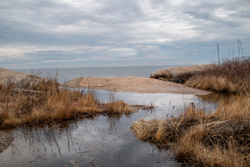 Winding river going toward the ocean on a cloudy day