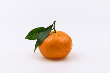 Fresh tangerine with green leaves isolated on white background