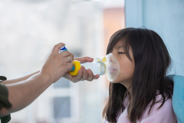 Mexican little girl with respiratory failure due to coronavirus pandemic using inhaler - obrazy, fototapety, plakaty