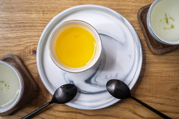 White cup with honey on a wooden table. Teaspoons. Tea ceremony