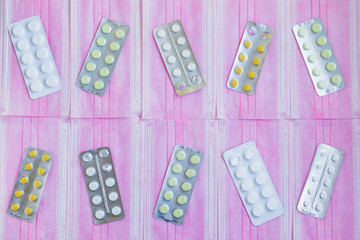 Medicines lie on medical masks.