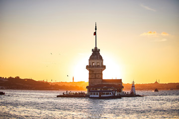 Fiery sunset over Bosphorus with famous Maiden's Tower (Kiz Kulesi in Turkish) also known as Leander's tower, symbol of Istanbul, Turkey