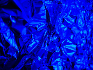 abstract trend blue background with texture of crumpled foil.