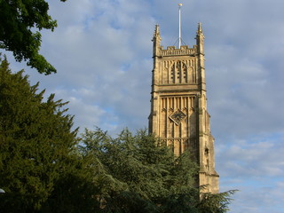 Fototapeta na wymiar Clock tower in England seen behind the trees