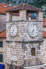 Fototapeta na wymiar Clock Tower, one of the most famous landmarks located on the Arms Square in historic part of Kotor, Montenegro