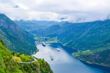 The cruise liners at the end of Geirangerfjord, near small village of Geiranger. View from Eagles Road. Norway.