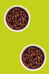 Two cups with coffee grains, flatlay, orange and lime background.