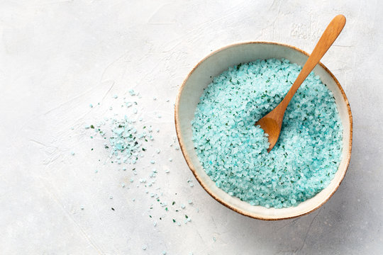 Home Spa. Blue Sea Salt With Seaweed For The Body In A Bowl On A Light Grey Table. Top View. Space For Text.