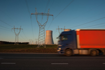 
orange truck driving along the highway near the Belarusian nuclear power plant near the town of Ostrovets