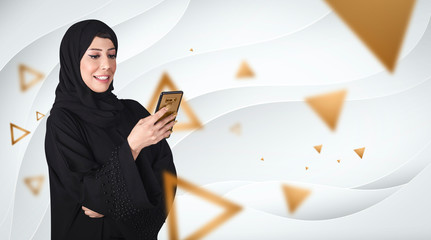 smiling Arabic woman using smart phone. Arabian Girl wearing black abaya  traditional Arab clothes....