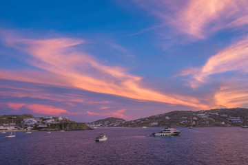 Sunset in Mykonos island, Greece with yachts in the harbor romantic spot on sunset. Mykonos town,...