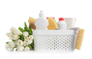 Set of cleaning supplies and spring flowers on white background