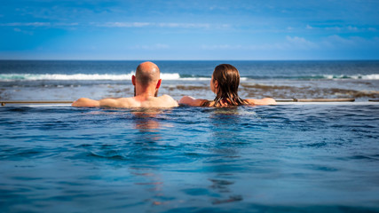 Beach couple relaxing on summer honeymoon vacation Reunion Island