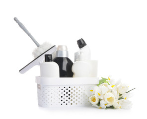 Set of cleaning supplies and spring flowers on white background