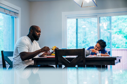 Single Dad And Daughter Eating Tacos For Dinner Together