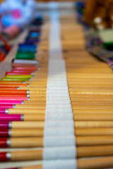 Colored artistic pencils in bag. Colored pencils background.