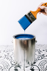 bucket of paint and brush