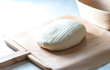 Fototapeta na wymiar Homemade bread. Ball of raw dough on wooden board on white background.