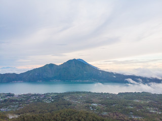 Naklejka na ściany i meble Scenic view of clouds and mist at sunrise from the top of mount Batur Kintamani volcano , Bali, Indonesia.