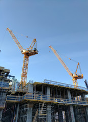 Fototapeta na wymiar Cranes on Construction Site
