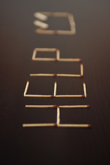 Help with corona, crown word from matches. Word help from matches on a black wood. Concept coronavirus, covid-19 of matches, the inscription Help.