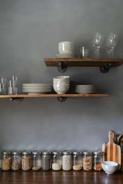 DIY European farmhouse rustic kitchen with gray lime wash wall and floating shelves