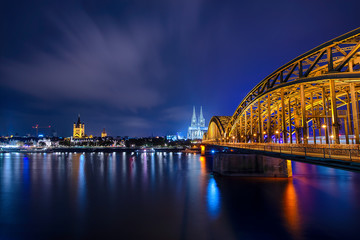 Panorama of the Hohenzollern Bridge over the Rhine River and Cologne Cathedral by night, Cologne...