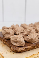 Chocolate cream on the cake. Preparing chocolate cake