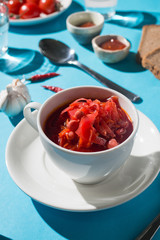 borsch soup with tomatoes and beets on a blue background 