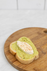 Sliced mozarella on the avocado spread toast