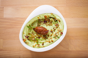 Organic plant based hummus with granola and dates. Perfect for vegan gluten free. Freshly homemade for takeaway and delivery. Arabic food photography.