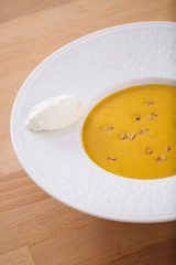 Delicious homemade pumpkin soup with seeds and goat cheese. Perfect for appetizer. Organic Arabic dish perfect for vegan. Healthy food photography.
