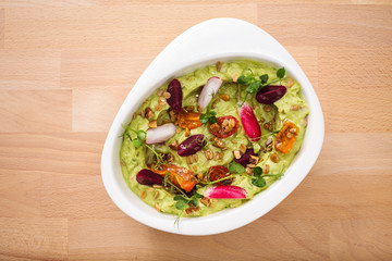 Organic plant based hummus with granola tomato, fresh thymes and rose leaf toppings. Perfect for vegan gluten free.