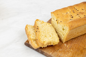Sliced homemade bread served on the wooden cutting board