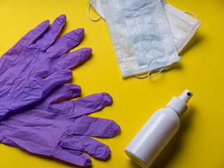 Pair of latex medical gloves on yellow background. Protection concept. COVID-19. Coronavirus. Facial masks. alcohol and gloves. Epidemic background. Quarantine background. thanks to the doctors
