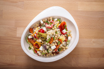 Healthy chick peas salad mixed with bell pepper cheese and dried tomatoes. Perfect for vegan. Freshly home made organic dish for take away and delivery.