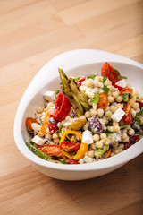 Healthy chick peas salad mixed with bell pepper cheese and dried tomatoes. Perfect for vegan. Freshly home made organic dish for take away and delivery.