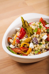 Healthy chick peas salad mixed with bell pepper cheese and dried tomatoes. Perfect for vegan. Freshly home made organic dish for take away and delivery.