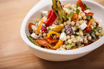Healthy chick peas salad mixed with bell pepper cheese and dried tomatoes. Perfect for vegan. Freshly home made organic dish for take away and delivery.
