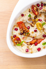 Organic plant based hummus with granola dried tomatoes toppings. Perfect for vegan gluten free. Freshly homemade for takeaway and delivery. Healthy food photography.
