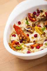 Organic plant based hummus with granola dried tomatoes toppings. Perfect for vegan gluten free. Freshly homemade for takeaway and delivery. Healthy food photography.