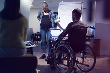Beautiful pregnant Businesswoman Gives Report/ Presentation to Her Business Colleagues in the Conference Room.