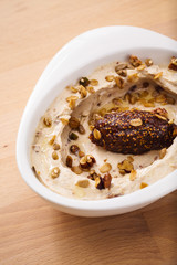 Organic plant based hummus with granola. Perfect for vegan gluten free. Freshly homemade for takeaway and delivery. Healthy food photography.