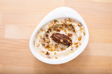 Organic plant based hummus with granola. Perfect for vegan gluten free. Freshly homemade for takeaway and delivery. Healthy food photography.