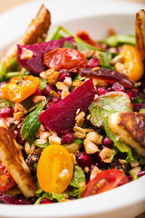 Tasty homemade vegan salad with granola grilled cheese beet root and cherry tomatoes. Organic food photography. For healthy living lifestyle. Food photography.
