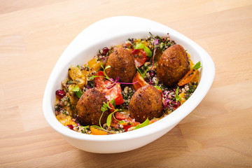 Delicious healthy salad with falafel and dried tomatoes. For healthy living. Perfect for takeaway and delivery. Vegan food photography.