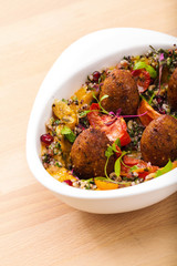 Delicious healthy salad with falafel and dried tomatoes. For healthy living. Perfect for takeaway and delivery. Vegan food photography.